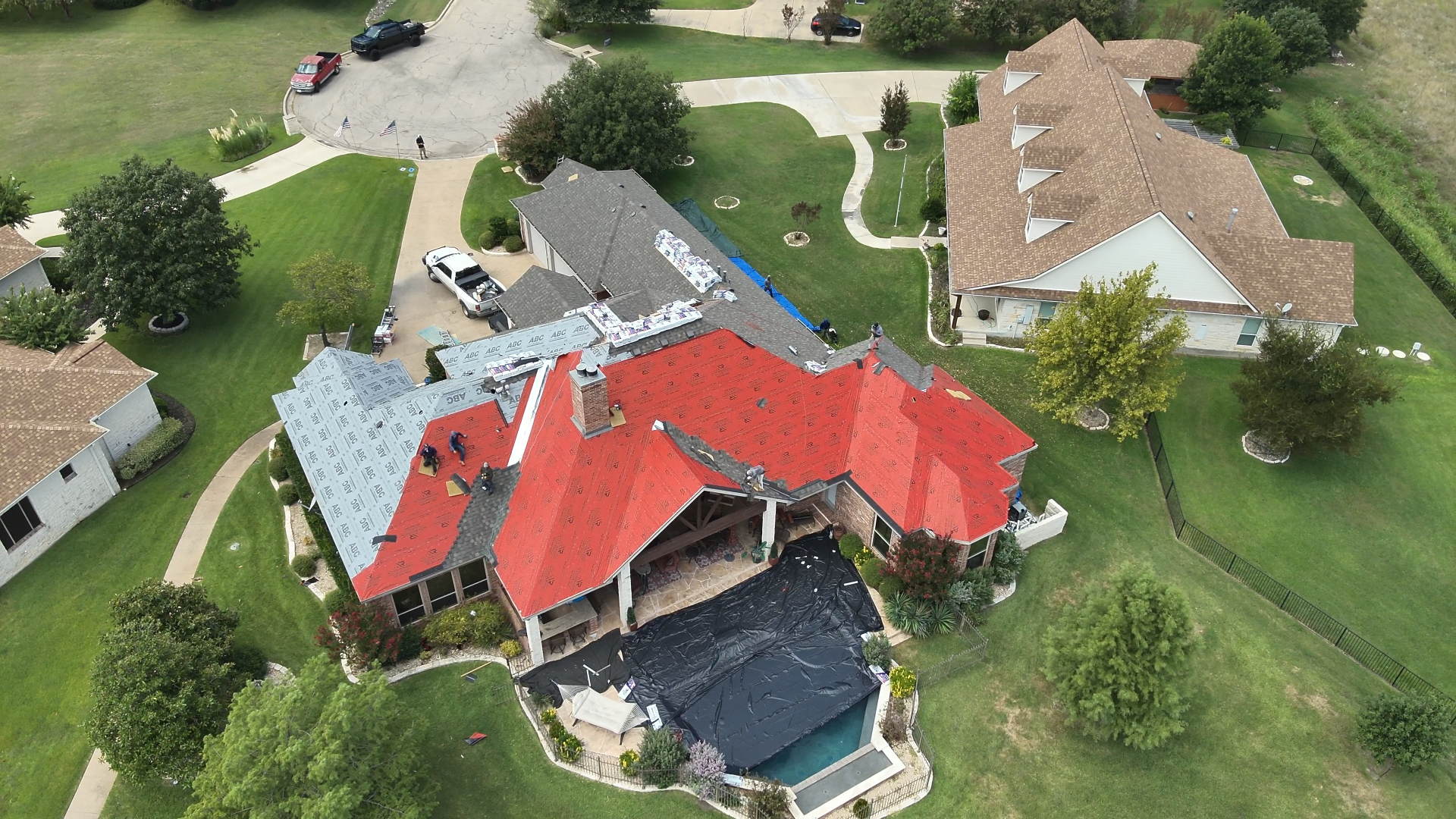 Aerial view of an Action Exteriors roof installation in progress in Tulsa
