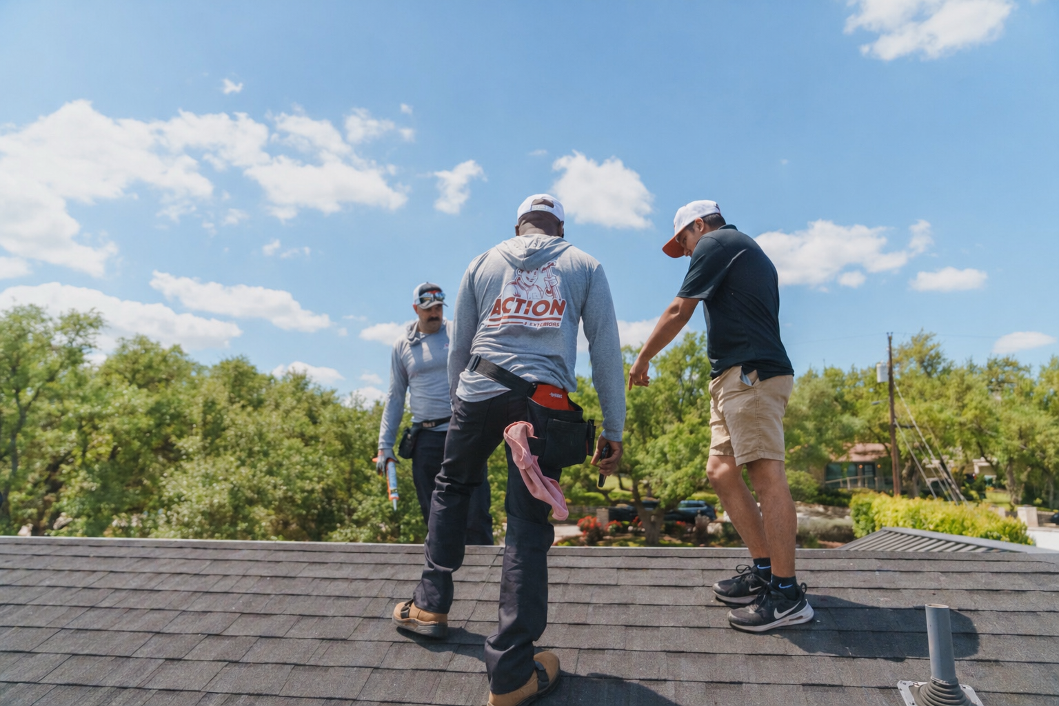 Action Exteriors crew working on a metal roof