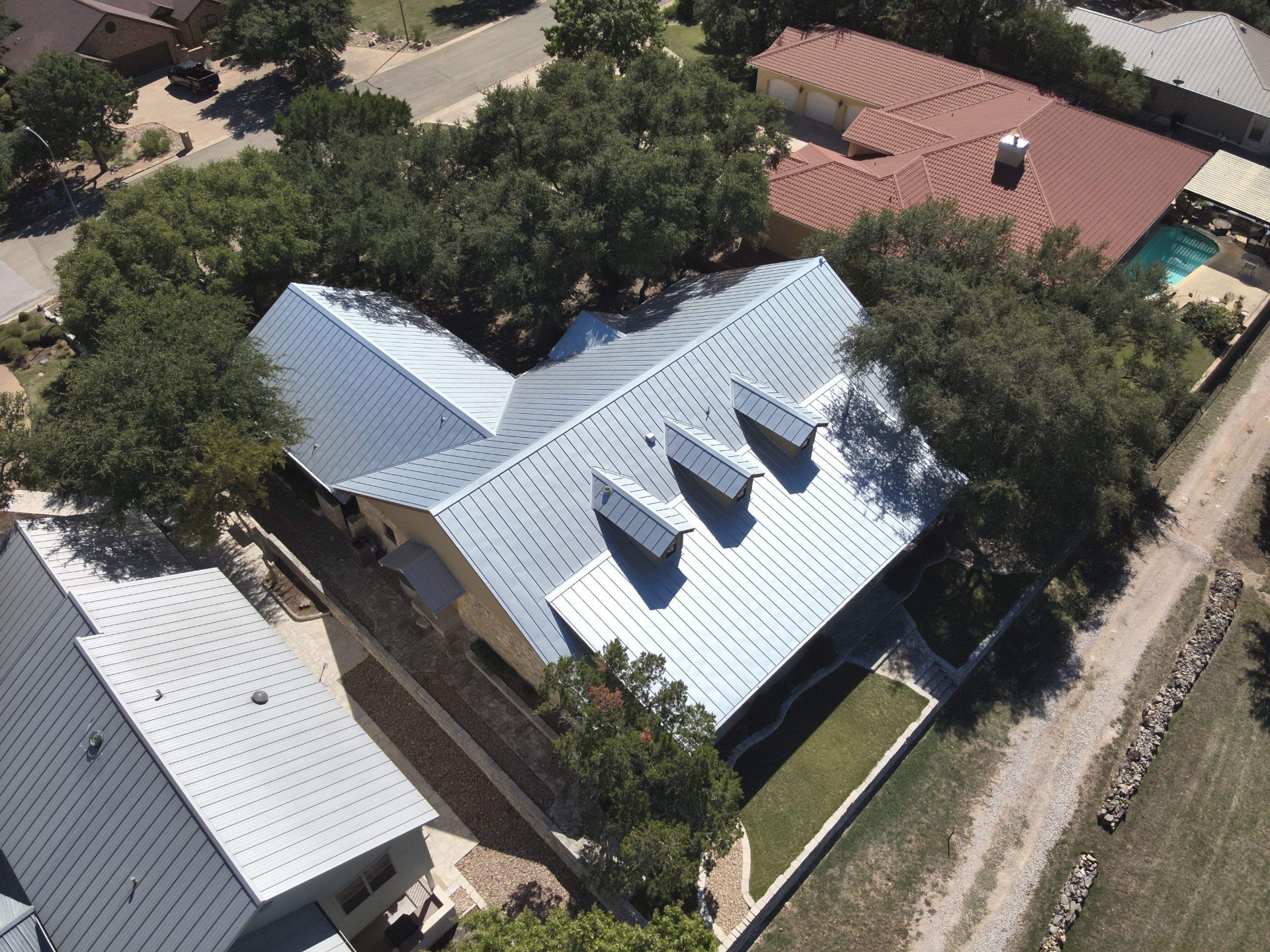 Aerial view of a standing seam metal roof installed by Action Exteriors
