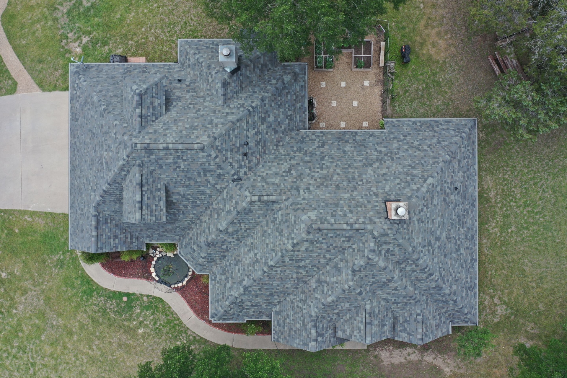 Aerial top-down view of new architectural shingle roof