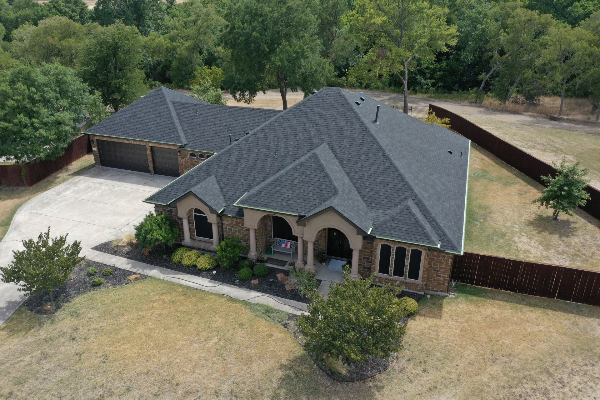 Shingle roof replacement on stone-arched home