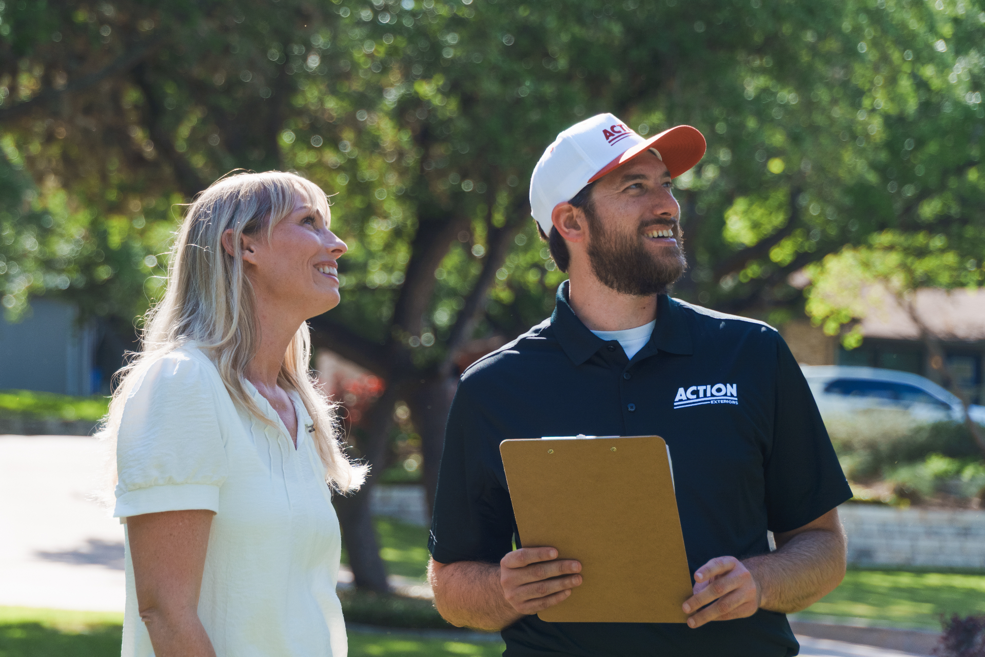 Action Exteriors rep consulting with a Tulsa homeowner
