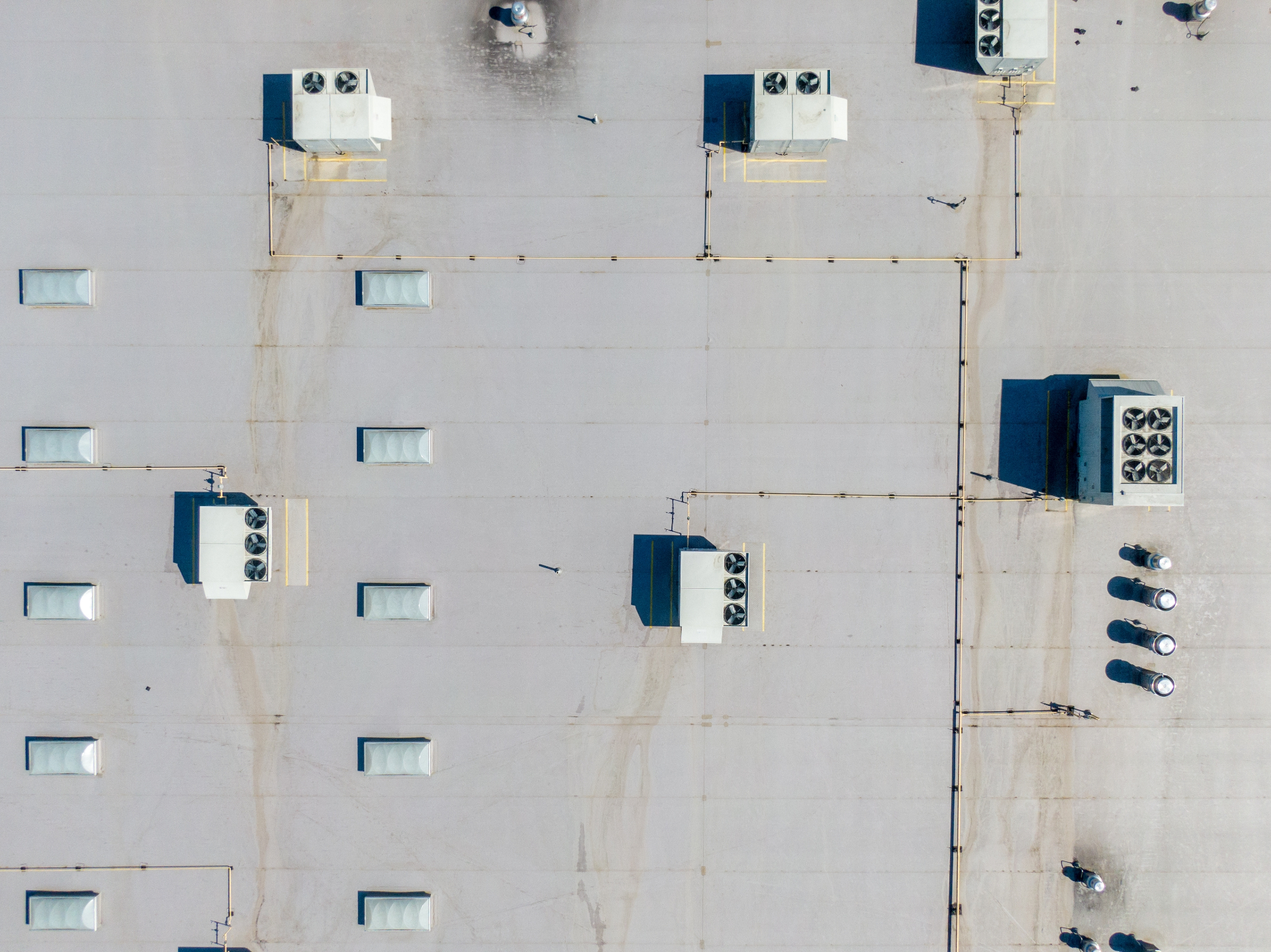 Aerial view of commercial flat roof with HVAC units in DFW