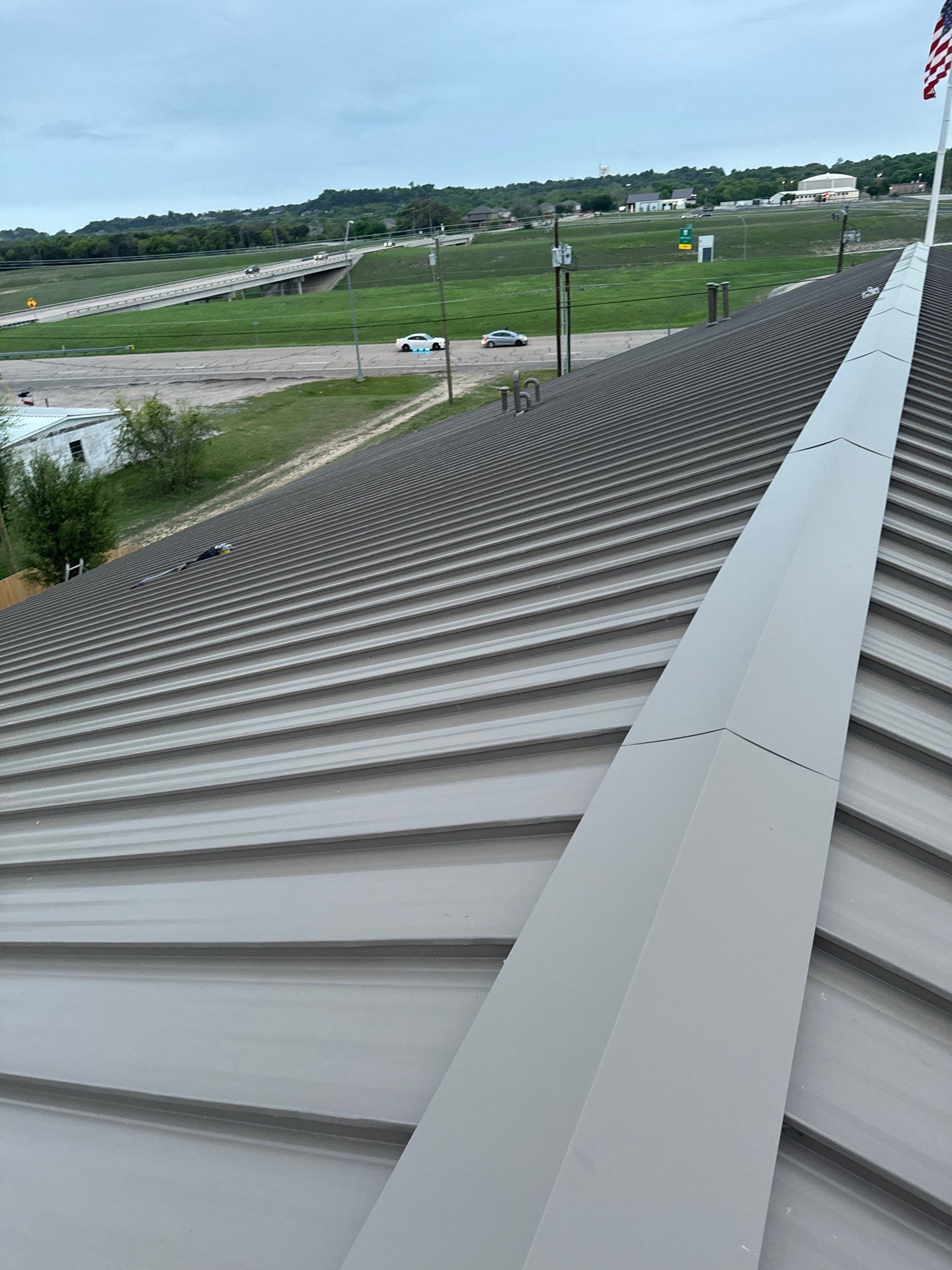 Metal roof panel close-up with ridge cap