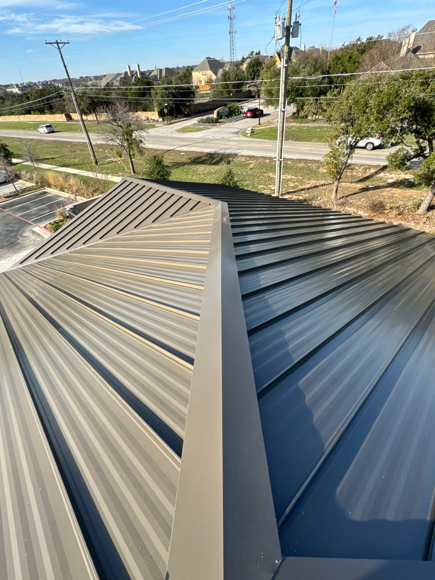 Two-tone standing seam metal roof intersection