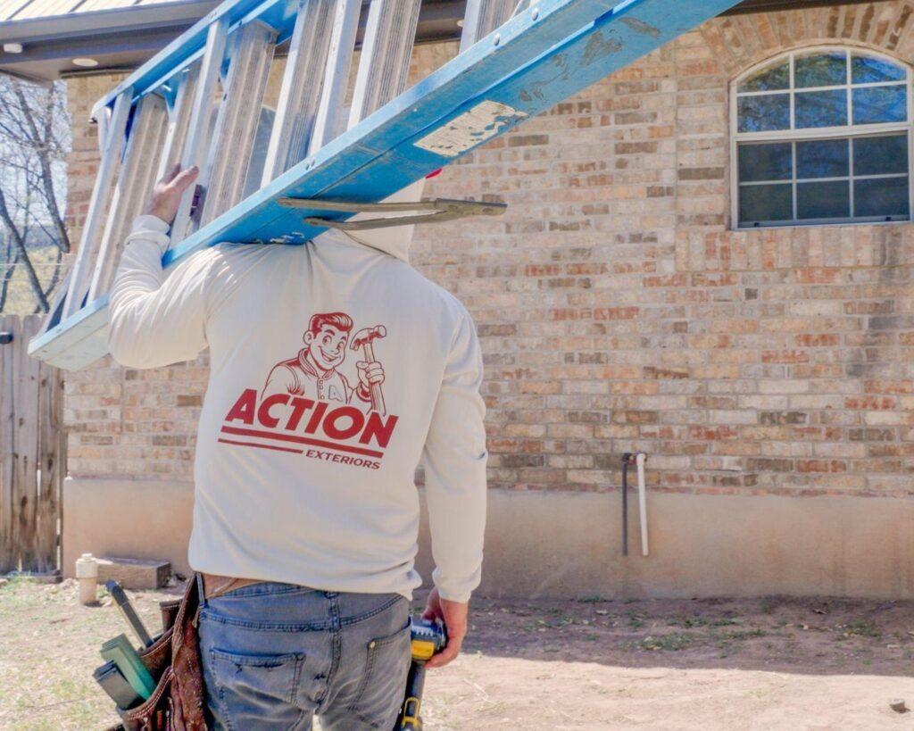 A professional roofer carrying a blue ladder for the roofing company Action Exteriors