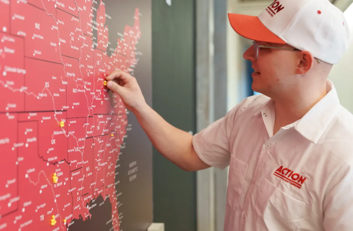 Franchisee pinning a new territory on the franchise map