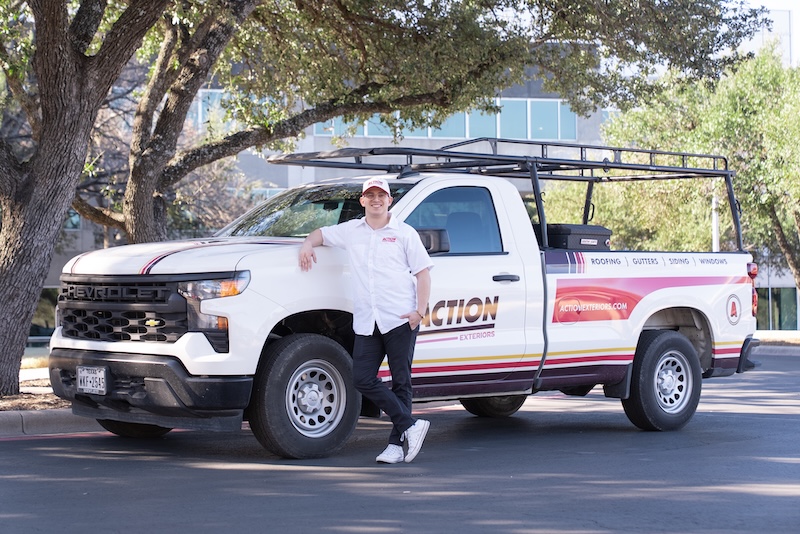 Franchise owner leaning on a branded Action Exteriors truck