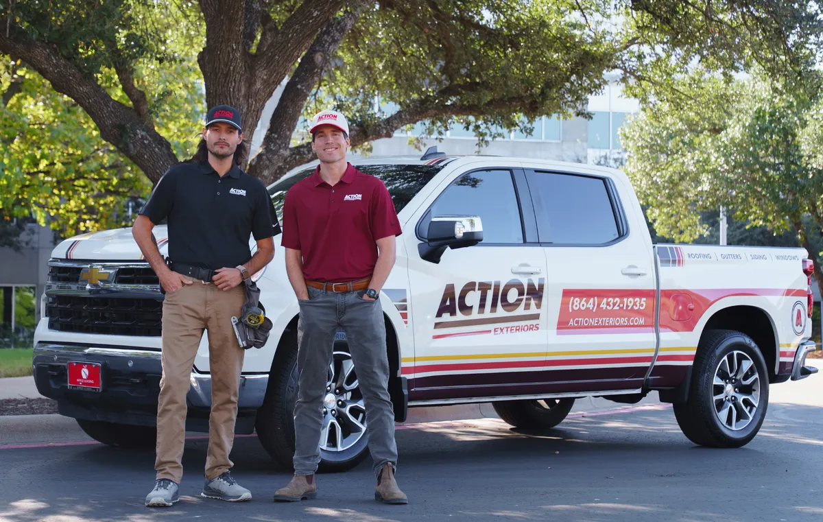 Franchise team standing in front of an Action Exteriors branded truck
