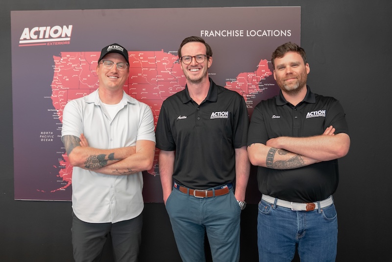 Action Exteriors leadership in front of the franchise locations map