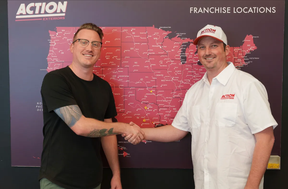 Franchise handshake in front of franchise locations map