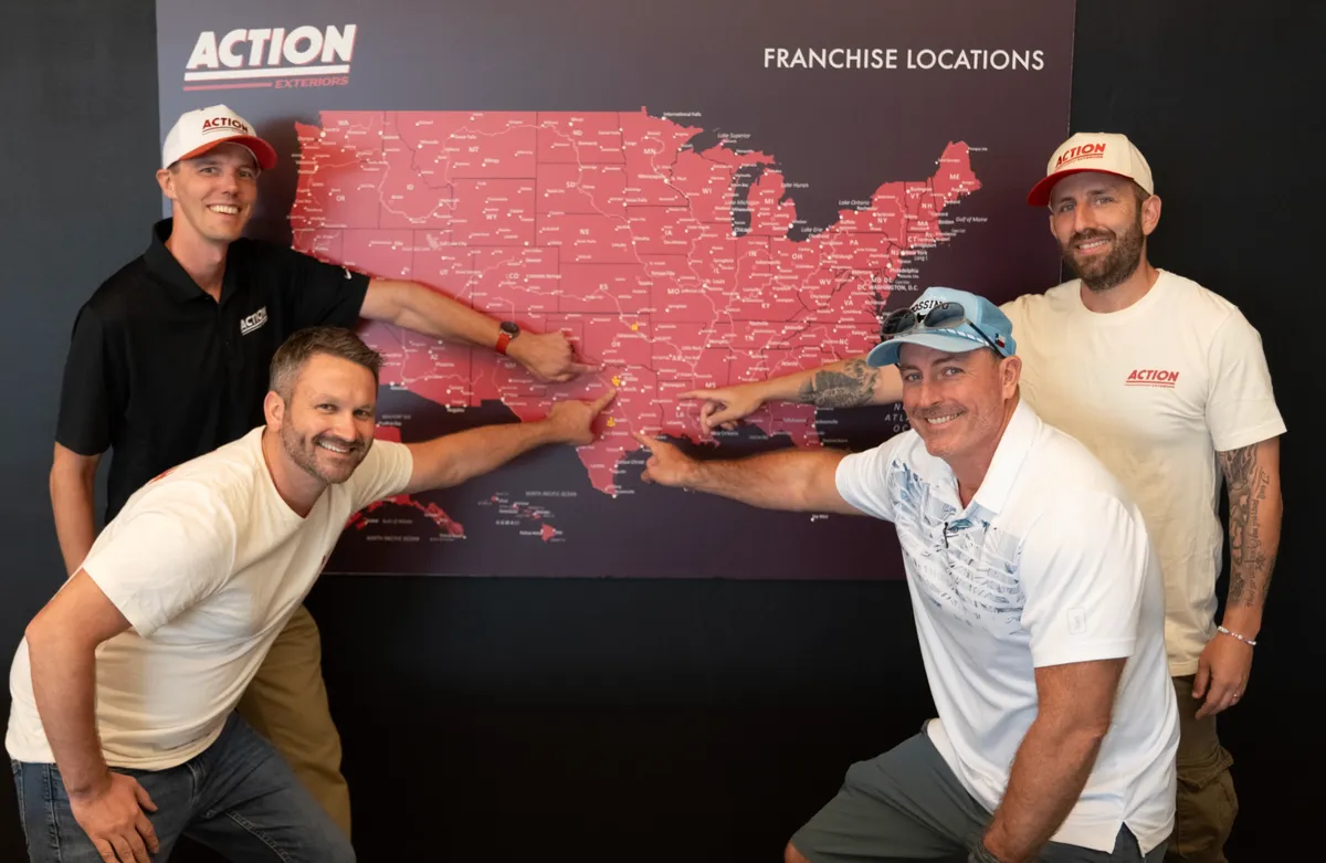 Franchise owners at launch event pointing to their territory on the map