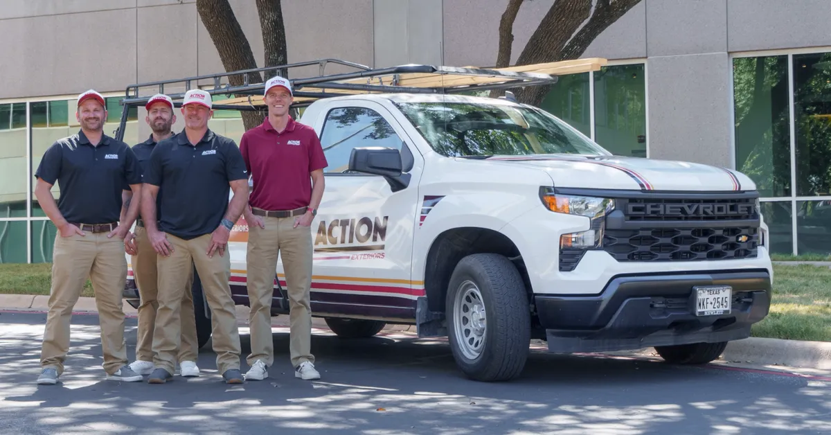 Action Exteriors team standing beside a branded truck