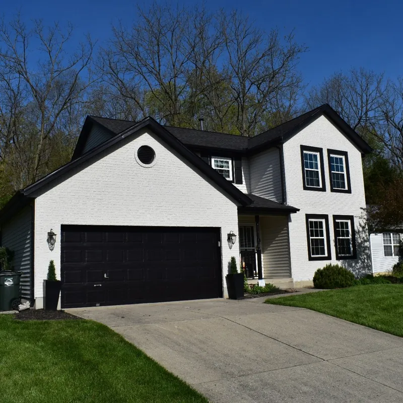Beautiful home showcasing roofing, siding, windows, and gutter services - Action Exteriors
