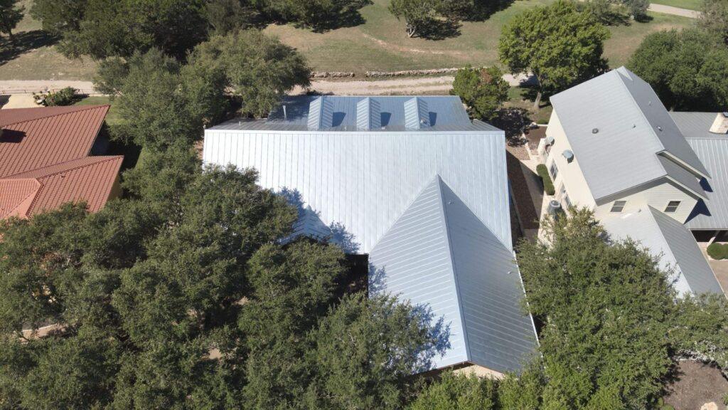 A completed metal roof services home by Action Exteriors Austin. - roofing in Round Rock
