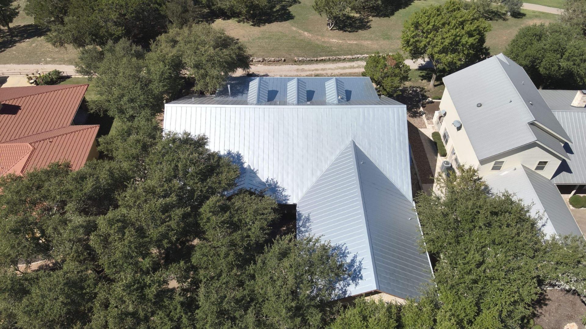 A completed metal roof services home by Action Exteriors Austin. - roofing in Round Rock