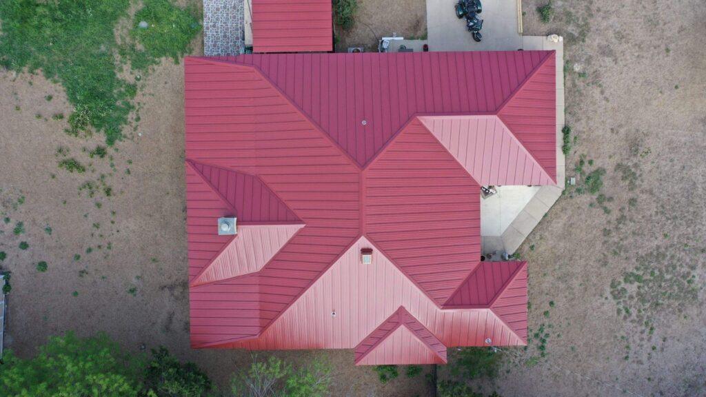A bird's eye view of a home with metal roofing done by Action Exteriors Austin.