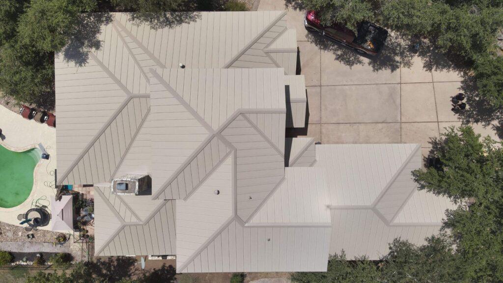 A bird's eye view of a residential roofing services being done by Action Exteriors Austin.