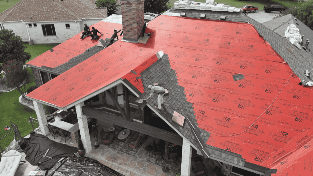 Residential Roof Repair drone shot of roofers putting on shingles_Action Exteriors roof services in austin