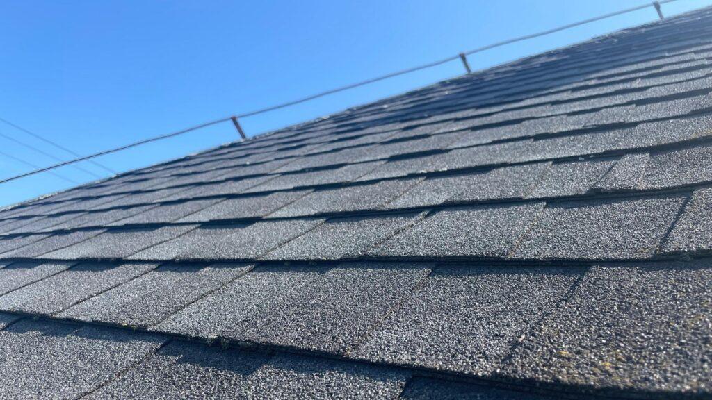 An angled photo of new shingles that were put on a home by Action Exteriors Austin.
