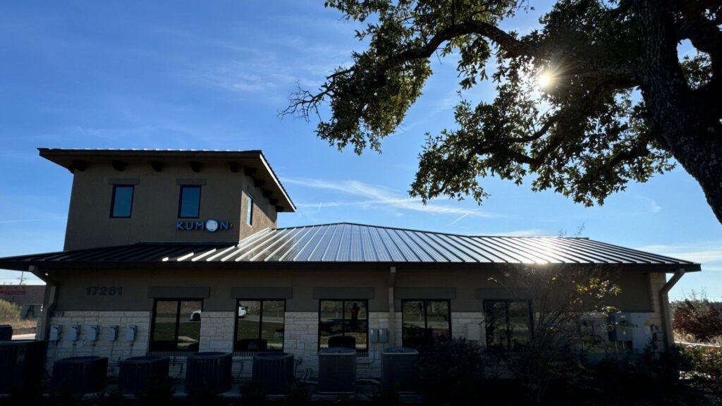 A shot of a commercial roof repair happening on a building that had its roof redone by Action Exteriors Austin.