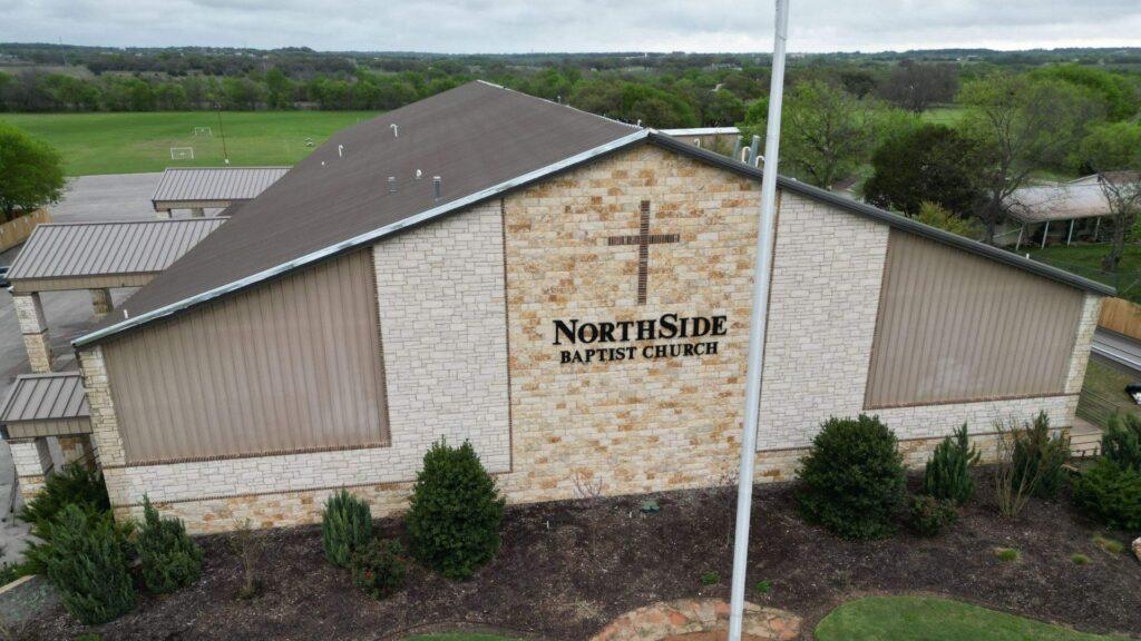 An image of the top of a church that had its roof fixed by Action Exteriors Austin.