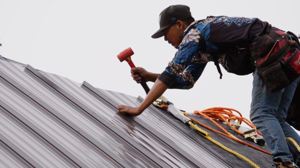 Roofing Repair_expert roofer repairing roof with specialized tools_Action Exteriors