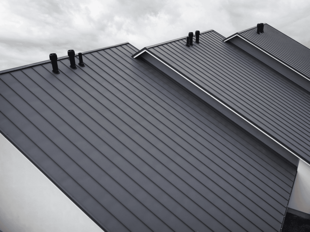 Commercial roof replacement on a dark metal roof by action exteriors roofing service