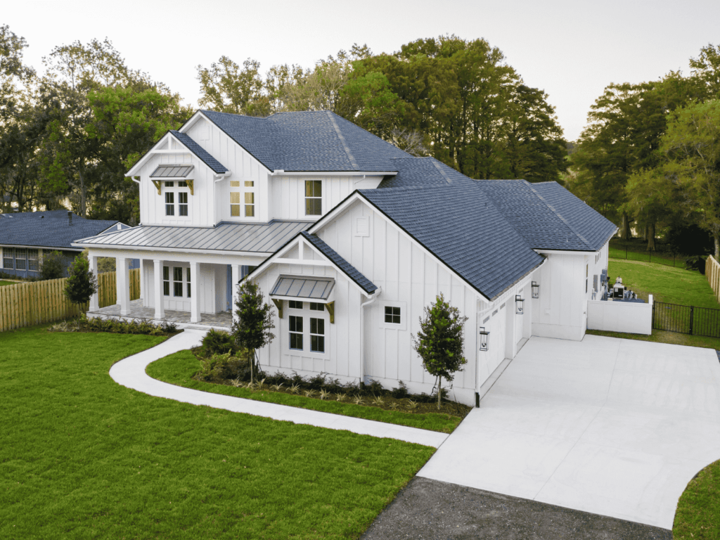 Beautiful modern white home with a new roof added by action exteriors_roofing services