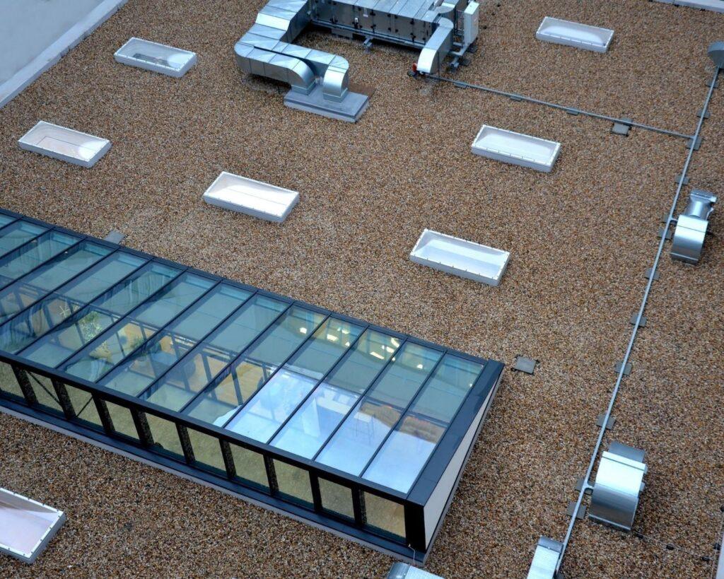 a complete commercial roof replacement done by action exteriors on a building with built up roofing