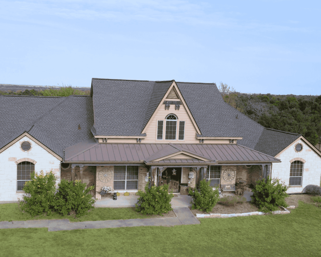 an after shot of a two story home in central texas with a new roof added by professional roofers at Action Exteriors