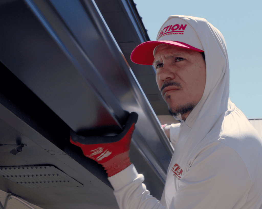 a tulsa roofer installing residential metal roofing panels onto a home_action exteriors