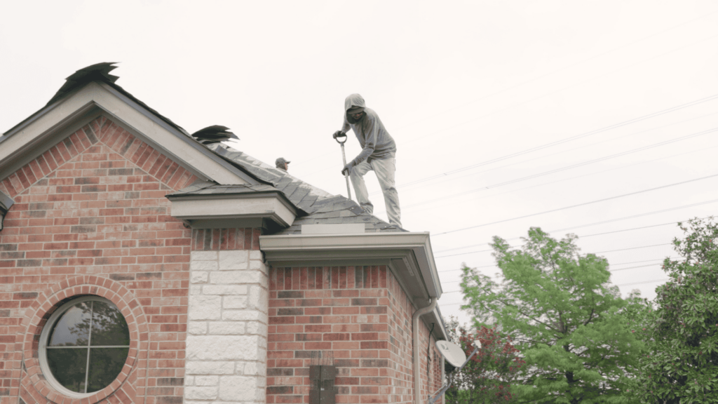 Roofing Contractor_Professional roofer working on shingles removal_Action Exteriors