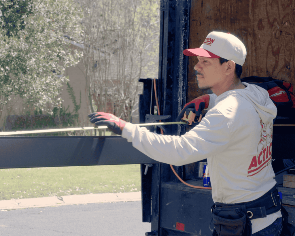 an action exteriors roofer unloading a metal panel out of a truck_tulsa