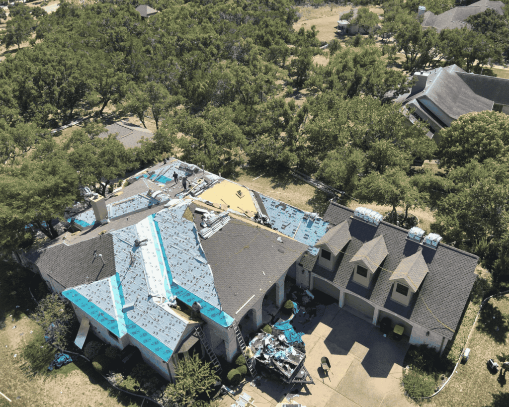 an aerial view of a tulsa home in the middle of a roof replacement renovation with exposed underlayment_action exteriors