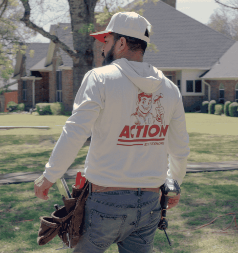 an action exteriors tulsa roofer wearing a branded white hoodie. Residential roof replacement