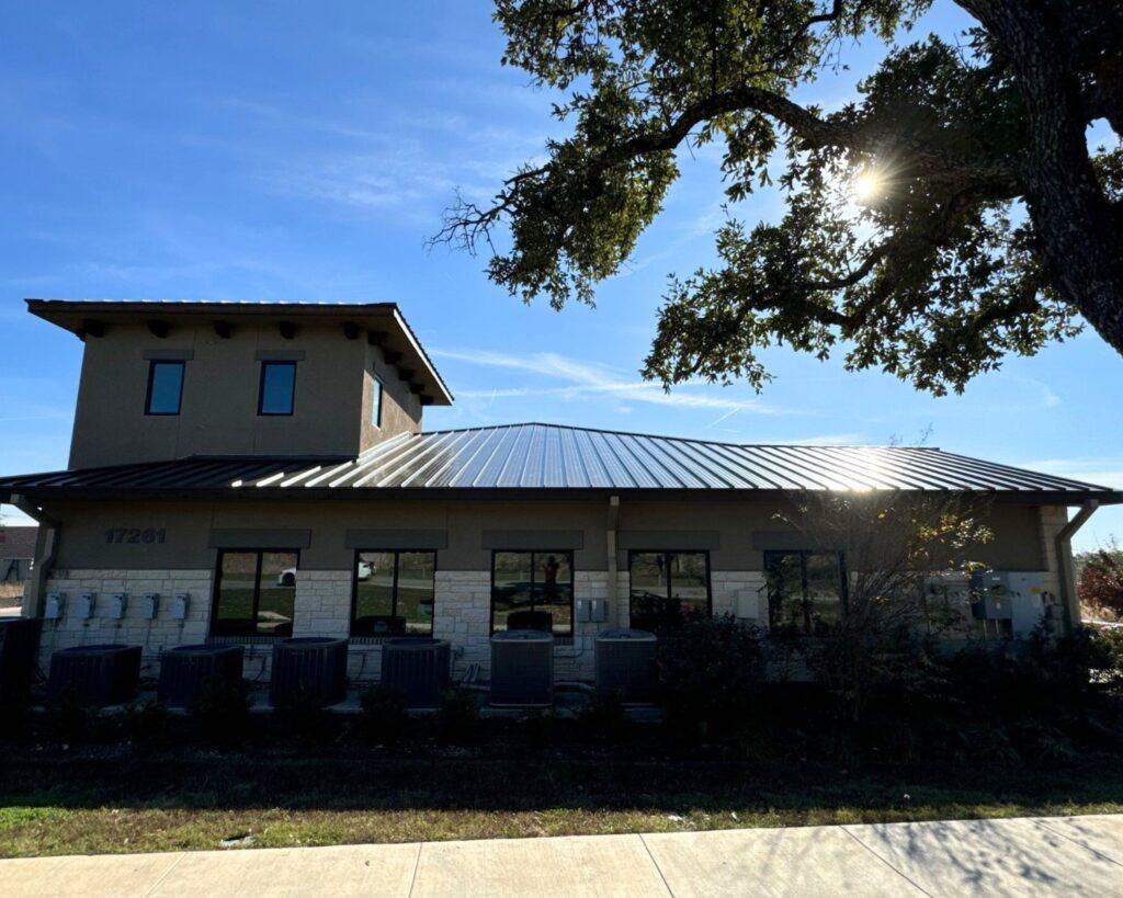 a ground shot of a commercial building with a recent roof replacement completed by action exteriors tulsa