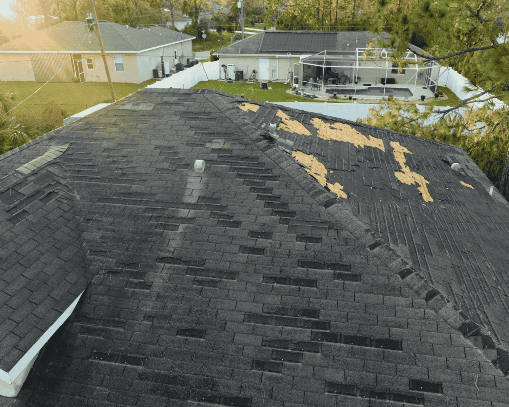 a home with missing shingles on its roof in need of emergency roof repair_action exteriors tulsa