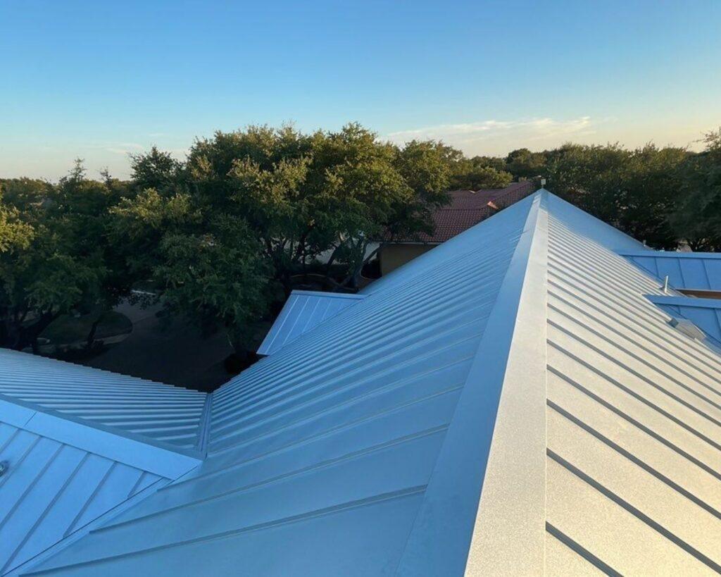 a silver metal roof of a residential home installed by Action Exteriors