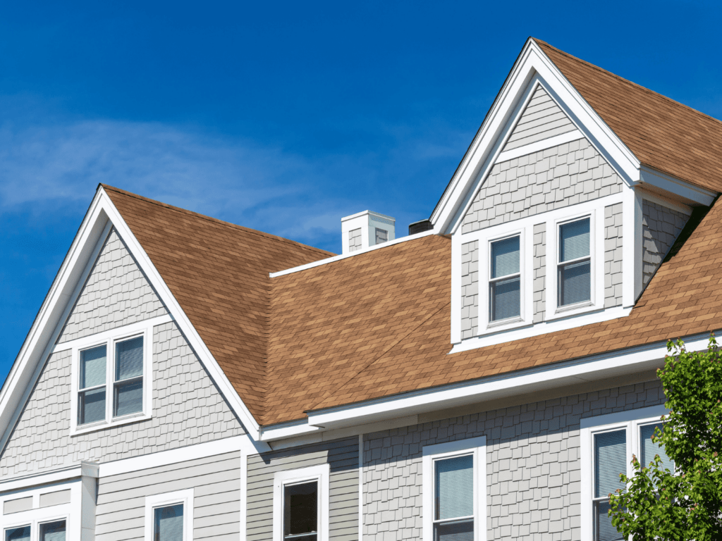 a gray two story home with a newly replaced brown roof_action exteriors