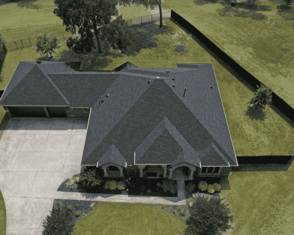 an aerial shot of a central texas home with a newly installed asphalt roof completed by action exteriors