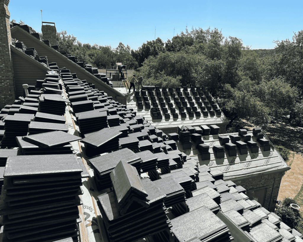 a roof-level image of slate shingles stacked on a house ready to be put on
