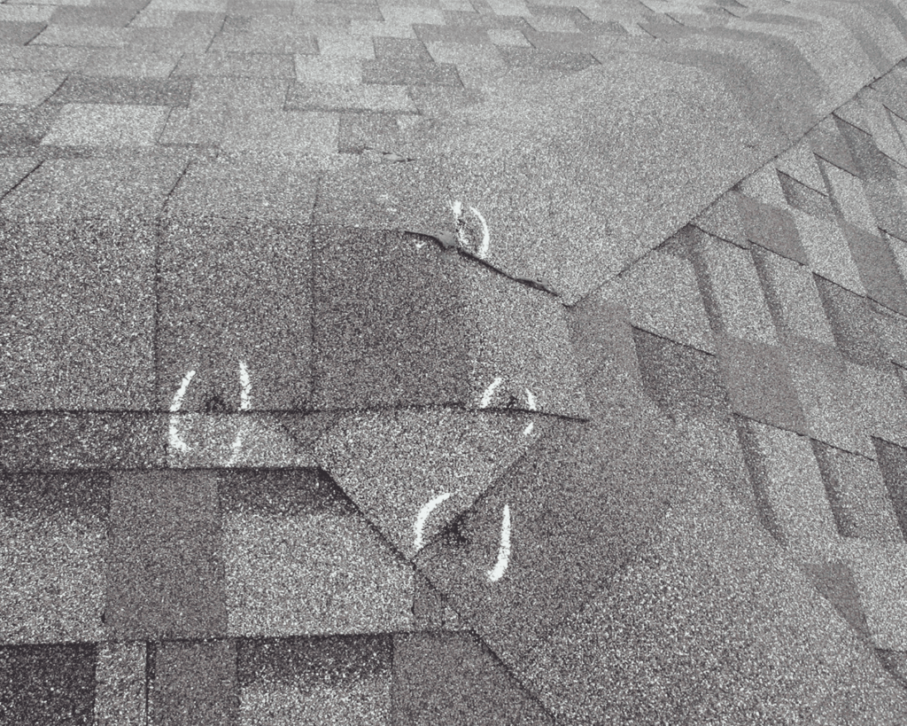a roof with white chalk marks indicating hail for emergency roof repair services_action exteriors - roof storm damage