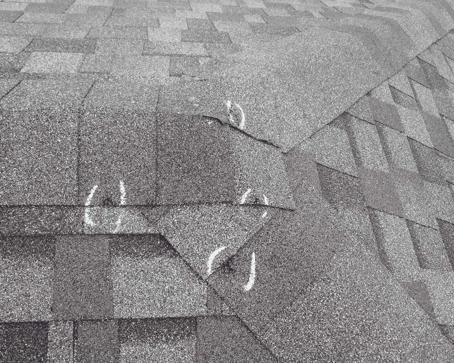 a roof with white chalk marks indicating hail for emergency roof repair services_action exteriors - roof storm damage